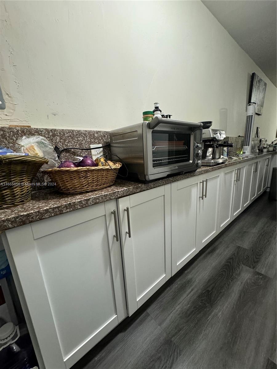 3551 Southwest 10th Street, Unit 8A Miami, FL 33135 - Photo 4 of 10 a kitchen with stainless steel appliances granite countertop a sink and a stove