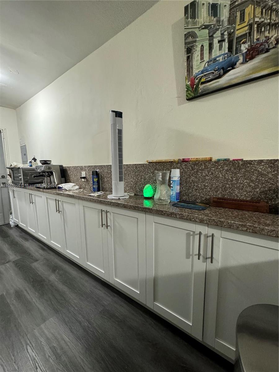 3551 Southwest 10th Street, Unit 8A Miami, FL 33135 - Photo 6 of 10 a kitchen with stainless steel appliances granite countertop a sink and a stove