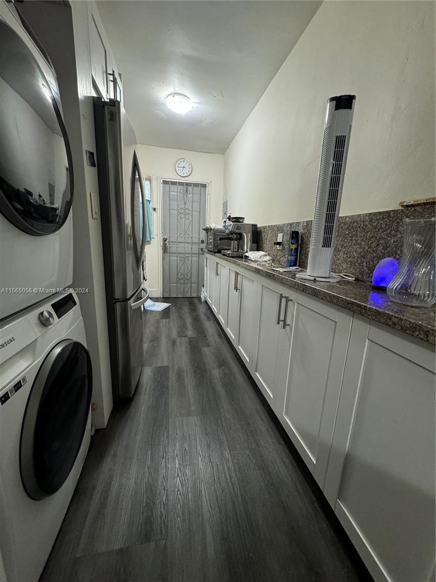 3551 Southwest 10th Street, Unit 8A Miami, FL 33135 - Photo 7 of 10 a kitchen with stainless steel appliances a sink a refrigerator a microwave a stove and wooden floors