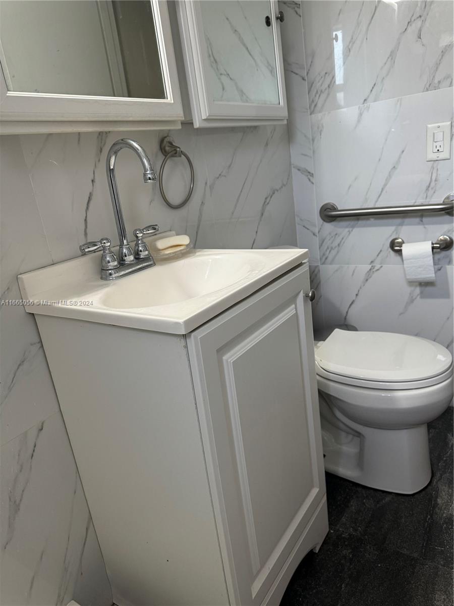 3551 Southwest 10th Street, Unit 8A Miami, FL 33135 - Photo 8 of 10 a bathroom with a sink toilet and vanity