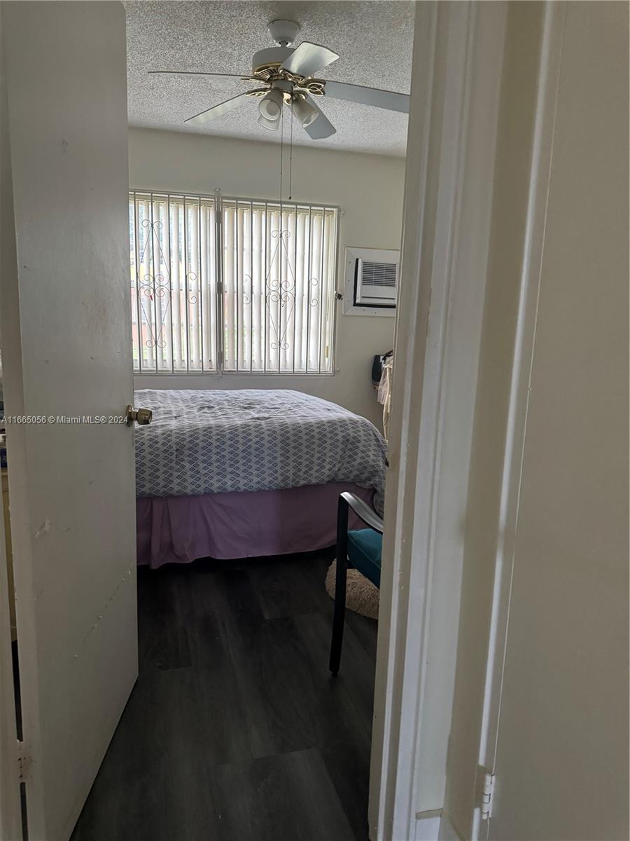 3551 Southwest 10th Street, Unit 8A Miami, FL 33135 - Photo 10 of 10 a bed sitting in a bedroom next to a window