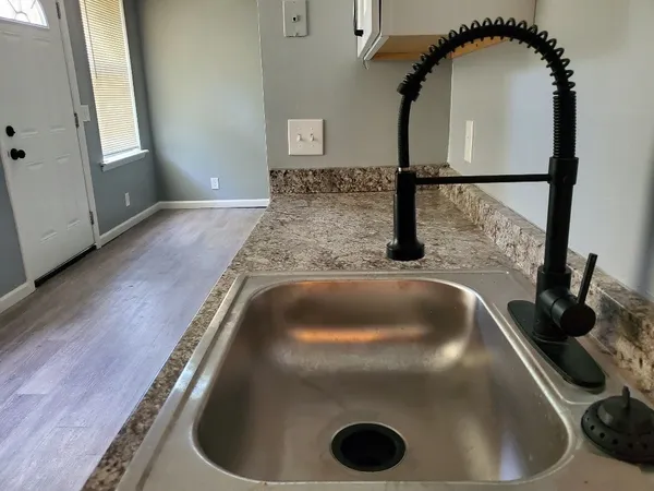 a kitchen with a sink and vanity