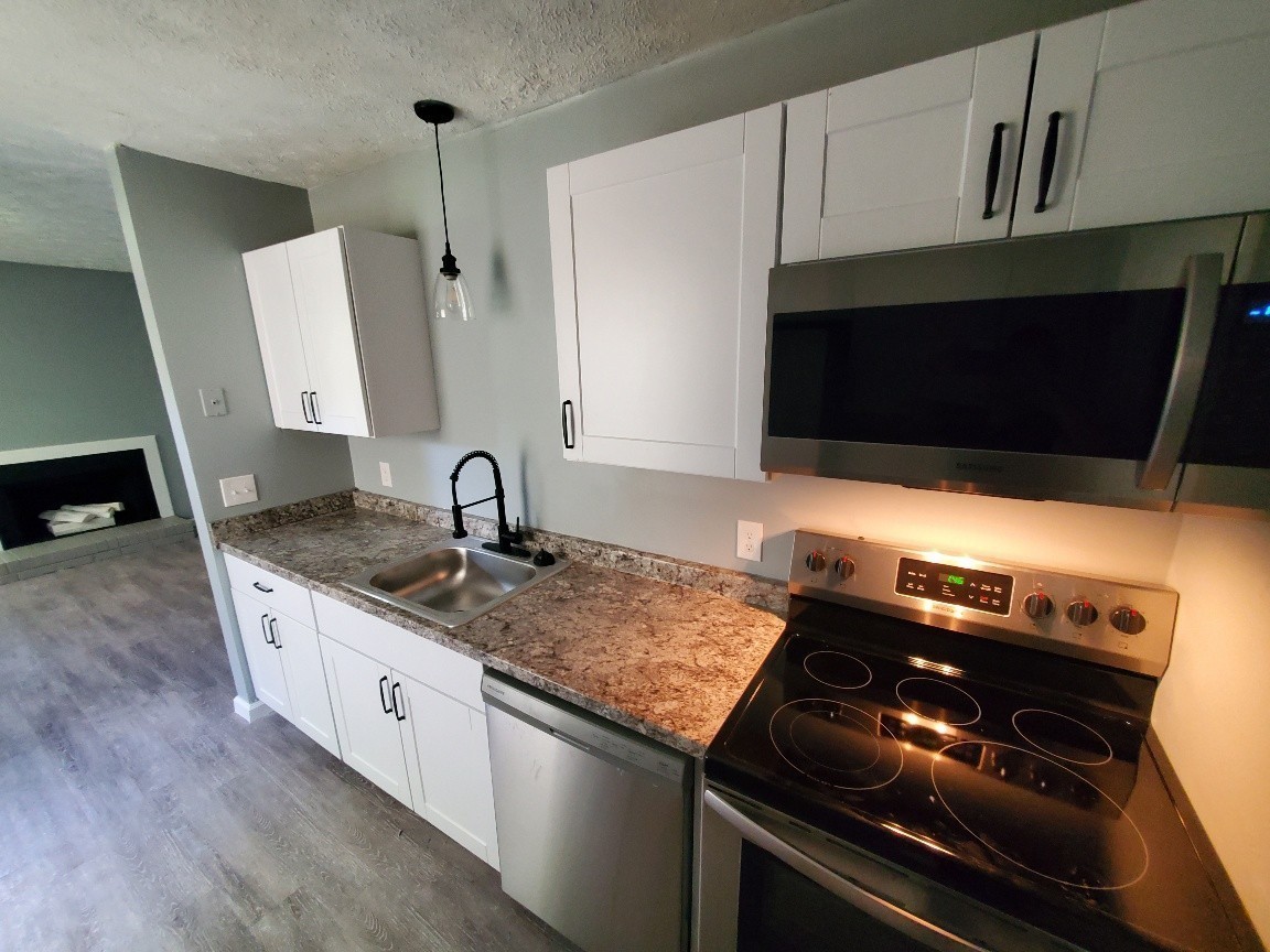 1317 Pierce Road Madison, TN 37115 - Photo 6 of 18 a kitchen with granite countertop a stove and a sink