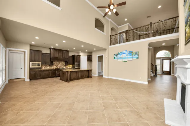 a large kitchen with kitchen island granite countertop a large counter top and wooden floor