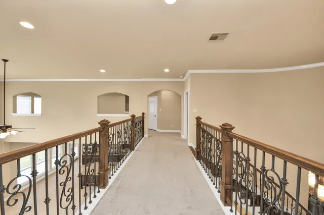 a view of an empty room with a ceiling fan