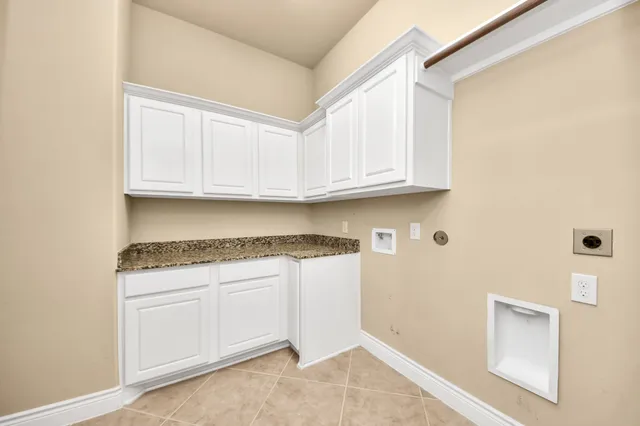 a view of hallway with refrigerator and wooden floor