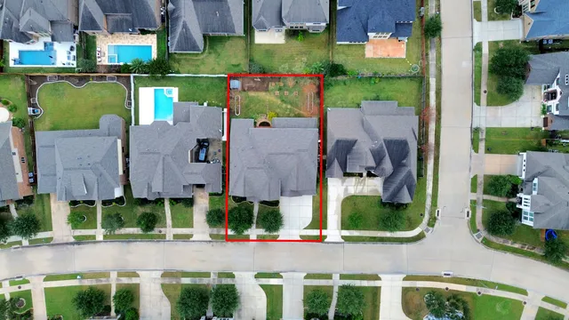 an aerial view of a house yard and mountain view in back