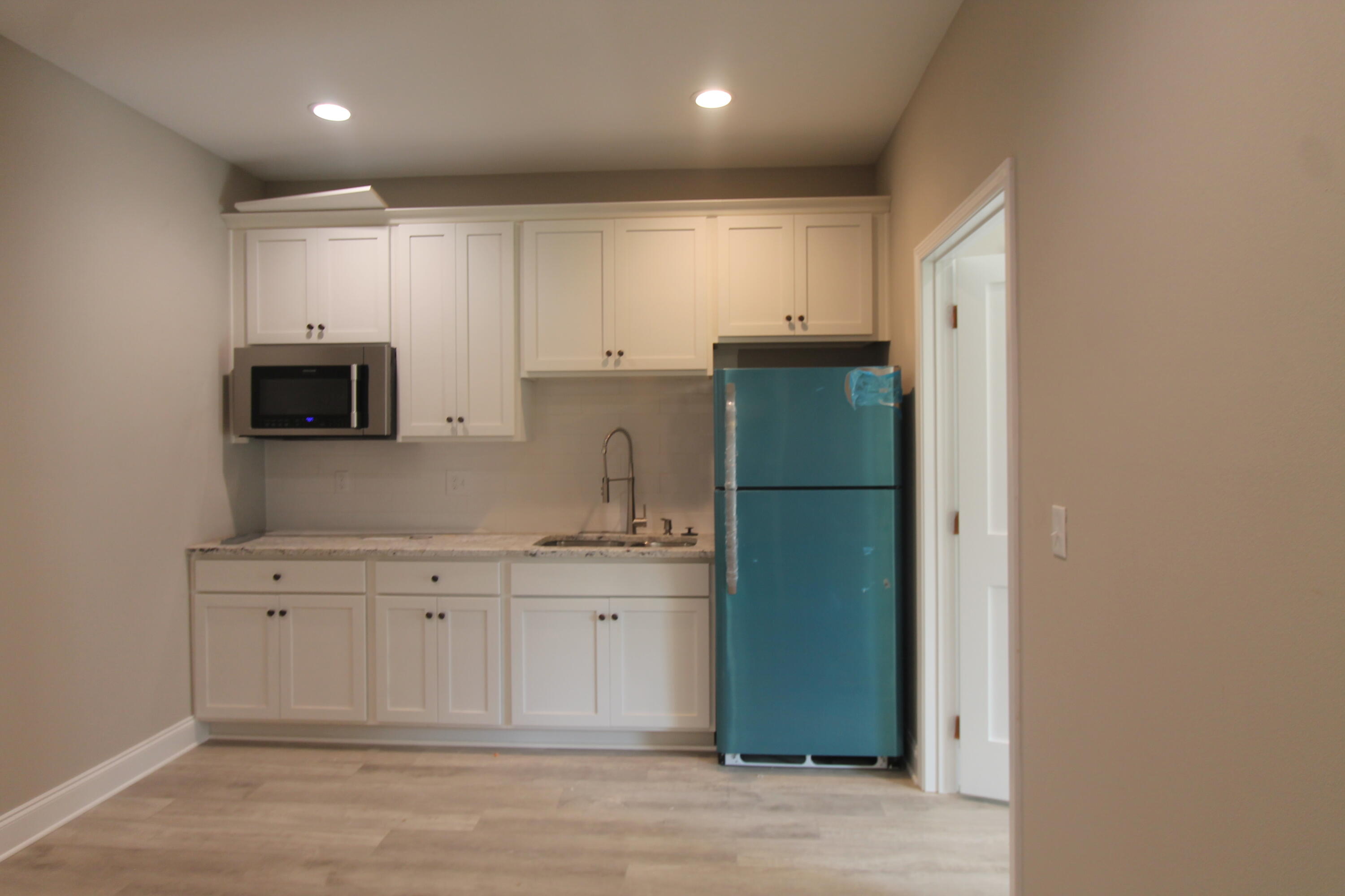 33 8th Avenue Shalimar, FL 32579 - Photo 11 of 13 a kitchen with a refrigerator and a microwave