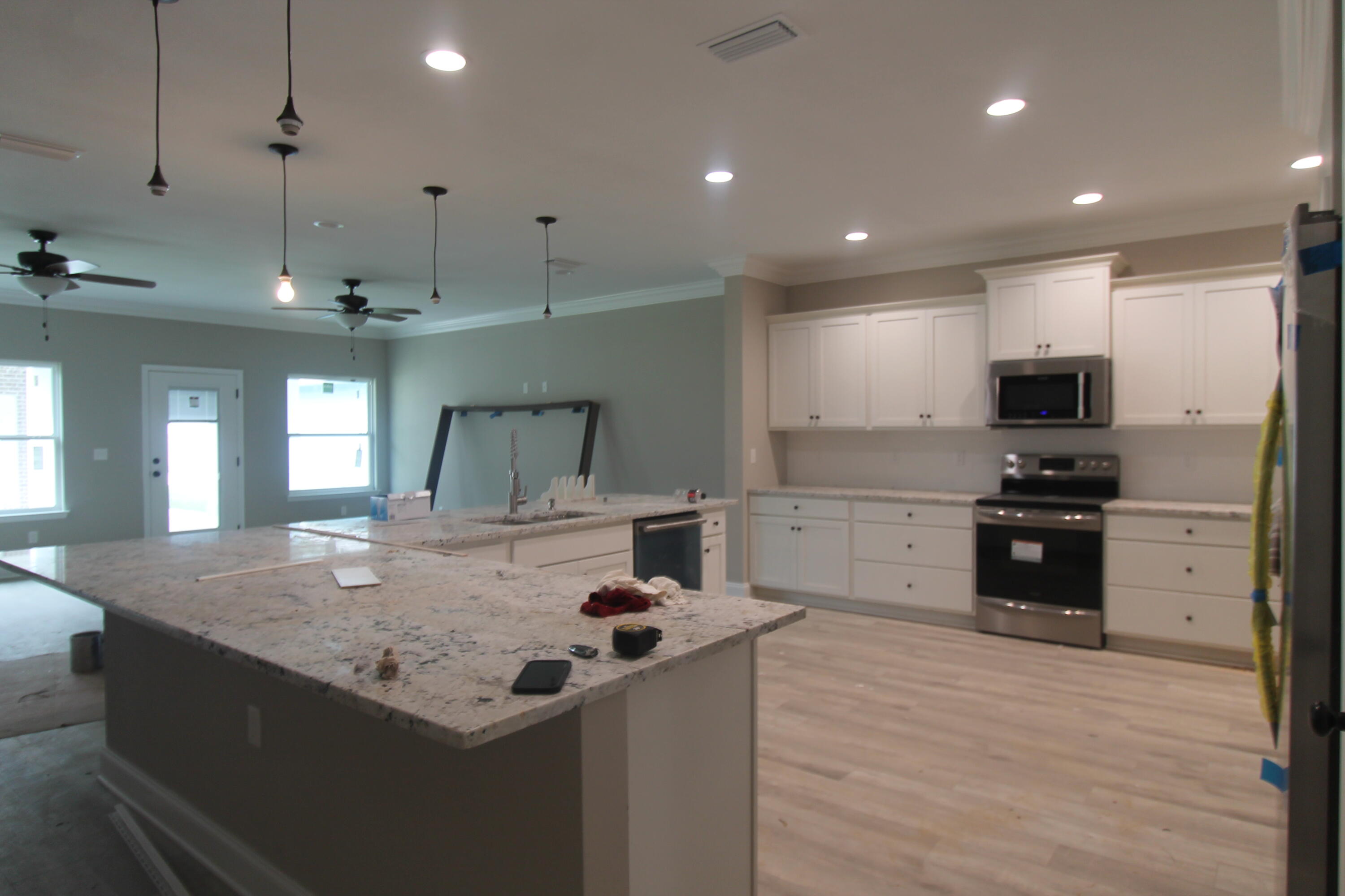33 8th Avenue Shalimar, FL 32579 - Photo 3 of 13 a kitchen with a sink stove and refrigerator