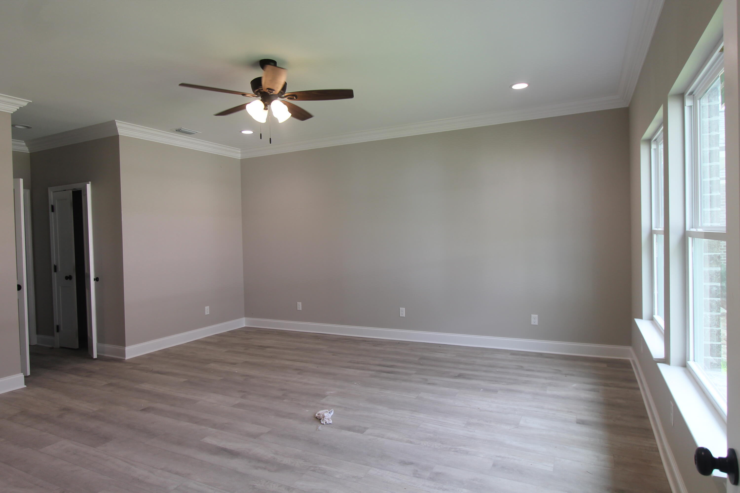 33 8th Avenue Shalimar, FL 32579 - Photo 7 of 13 an empty room with wooden floor fan and windows