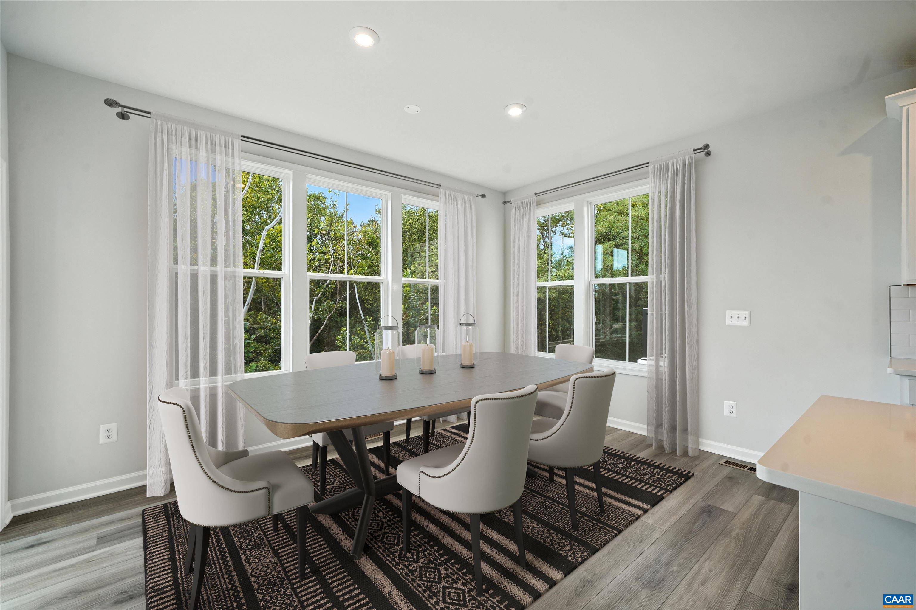 3071 Rambling Brk Lane Crozet, VA 22932 - Photo 2 of 38 a dining room with furniture a rug and wooden floor