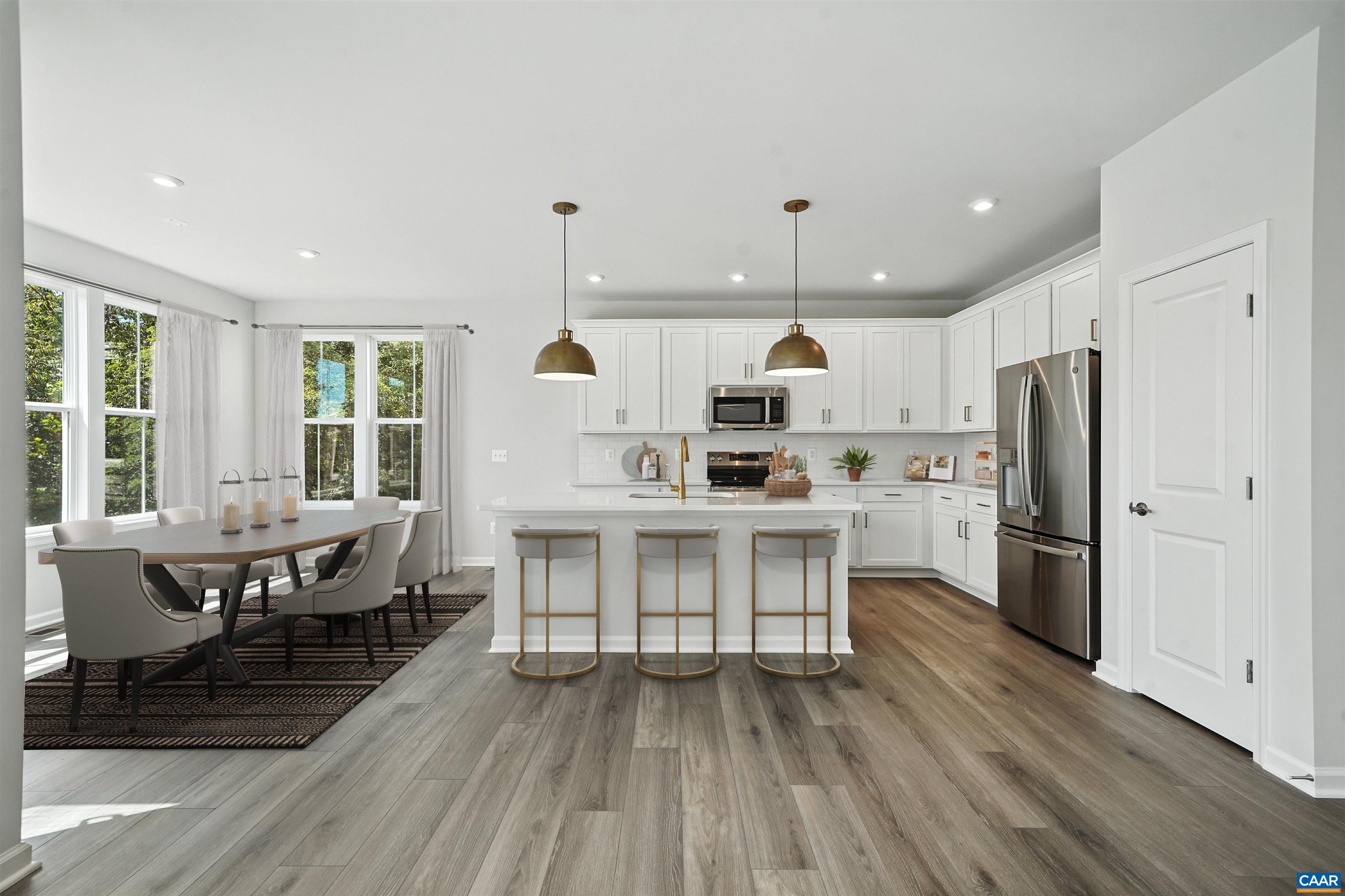 3071 Rambling Brk Lane Crozet, VA 22932 - Photo 6 of 38 a kitchen with kitchen island wooden floors appliances and white cabinets