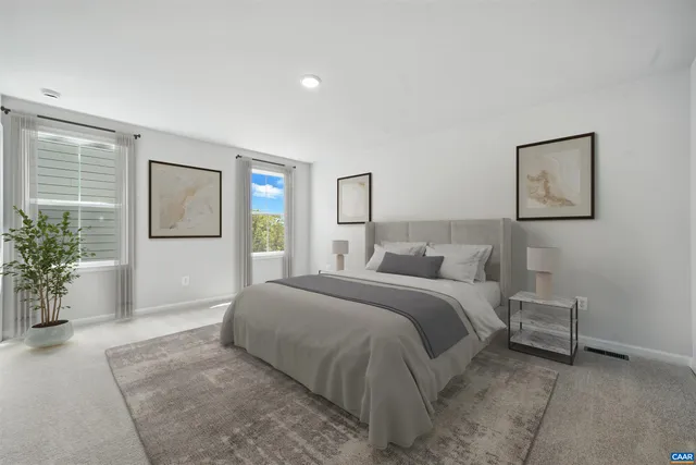 a spacious bedroom with a bed and a potted plant