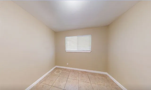 a view of an empty room with a window