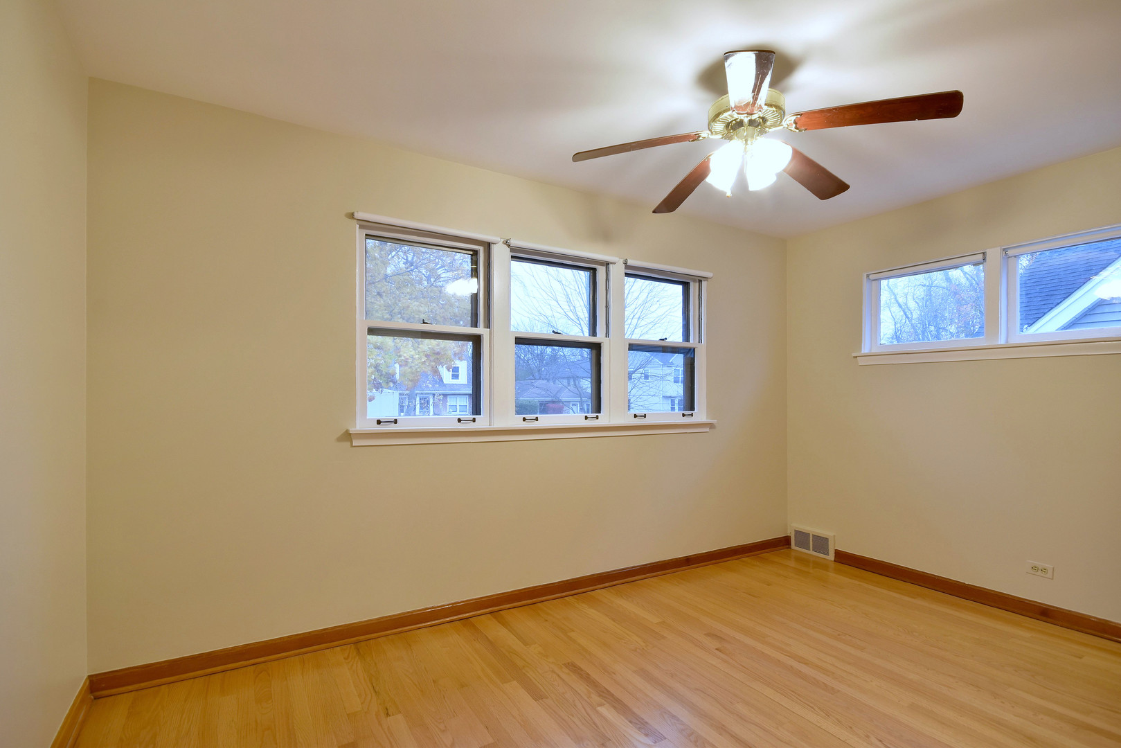 632 Bryan Street Elmhurst, IL 60126 - Photo 11 of 33 a view of an empty room with wooden floor and a window