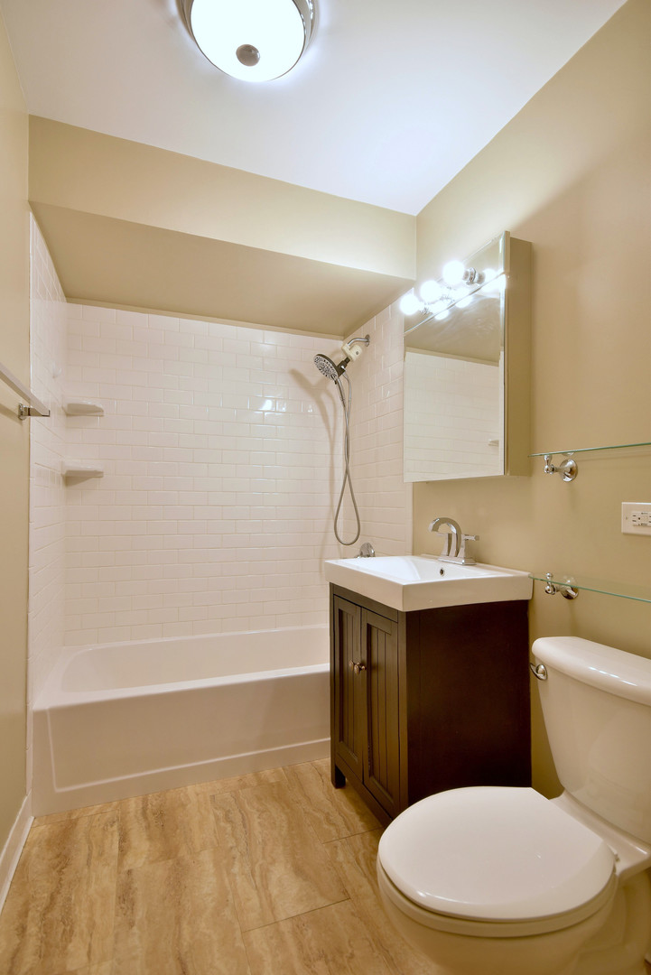 632 Bryan Street Elmhurst, IL 60126 - Photo 16 of 33 a bathroom with a sink a toilet and shower