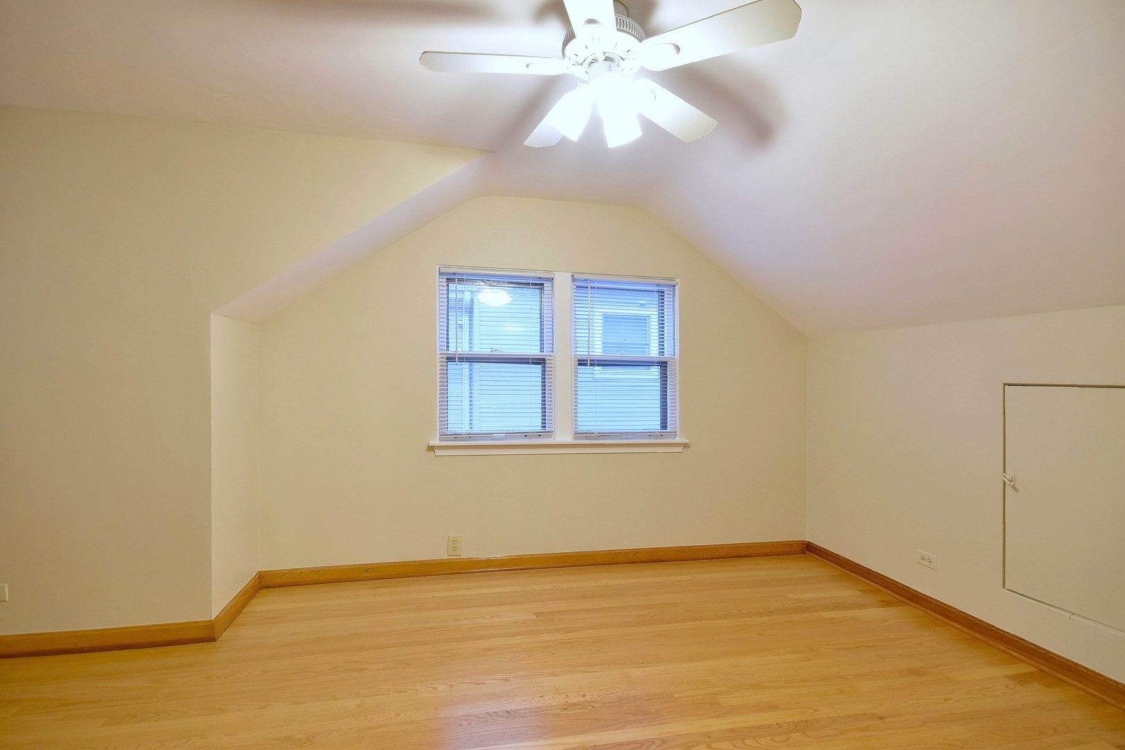 632 Bryan Street Elmhurst, IL 60126 - Photo 17 of 33 an empty room with a chandelier fan and windows