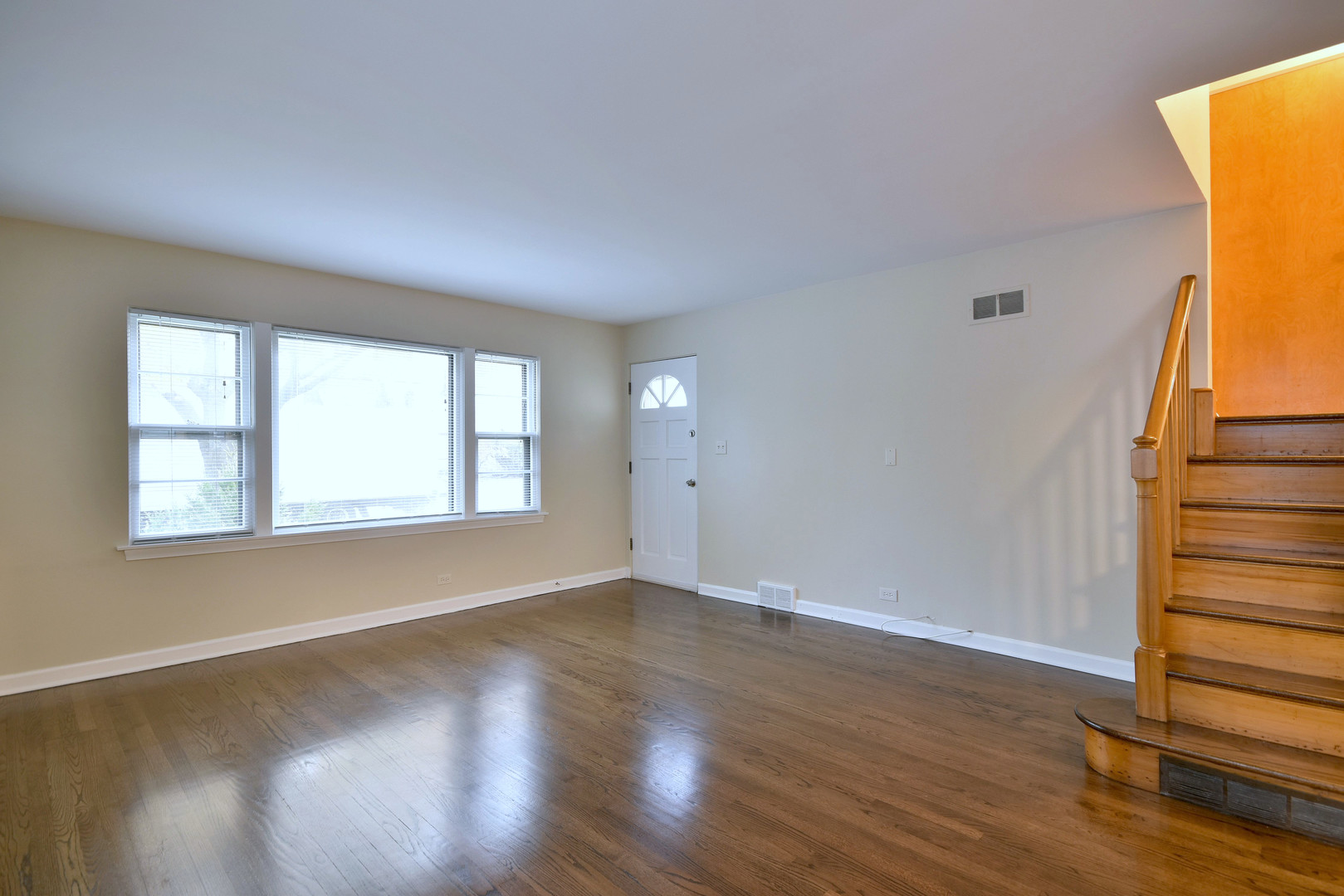 632 Bryan Street Elmhurst, IL 60126 - Photo 3 of 33 a view of an empty room with wooden floor and a window