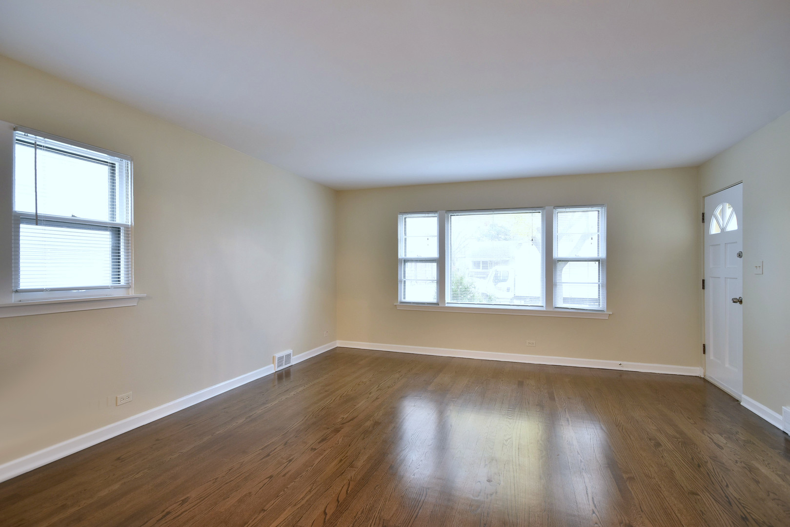 632 Bryan Street Elmhurst, IL 60126 - Photo 5 of 33 a view of an empty room with wooden floor and a window