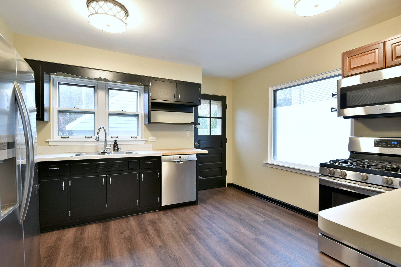632 Bryan Street Elmhurst, IL 60126 - Photo 6 of 33 a kitchen with stainless steel appliances granite countertop a stove a sink and a microwave