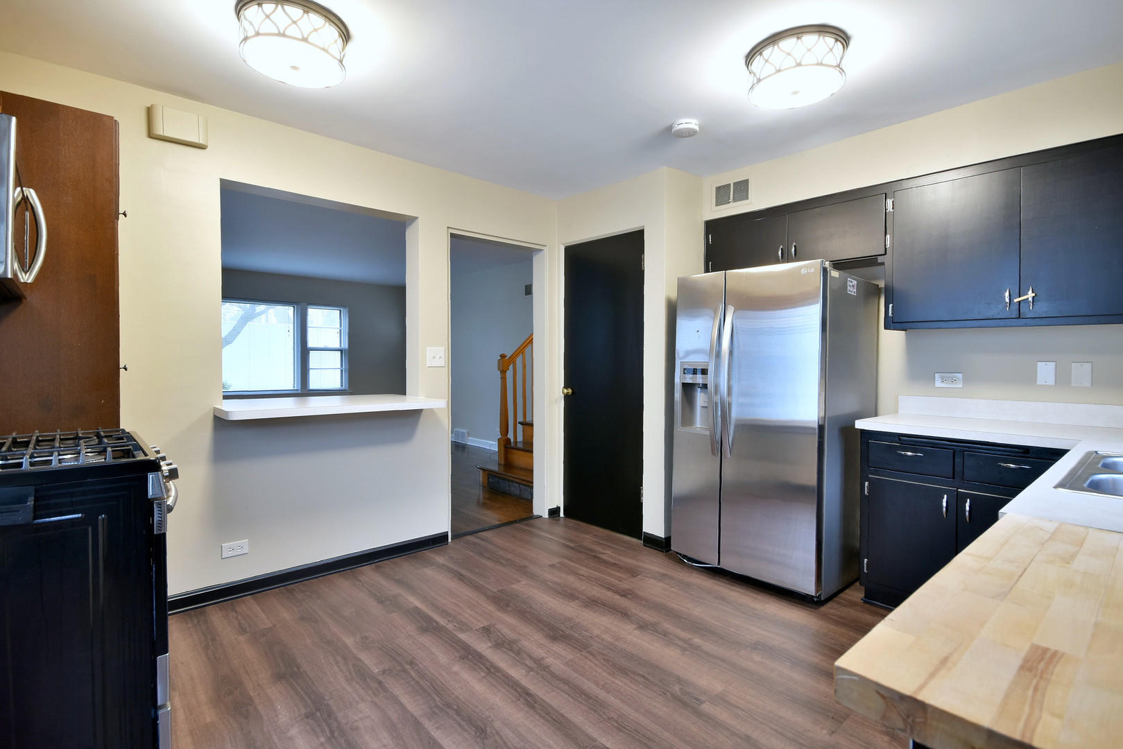 632 Bryan Street Elmhurst, IL 60126 - Photo 7 of 33 a kitchen with a refrigerator and a sink