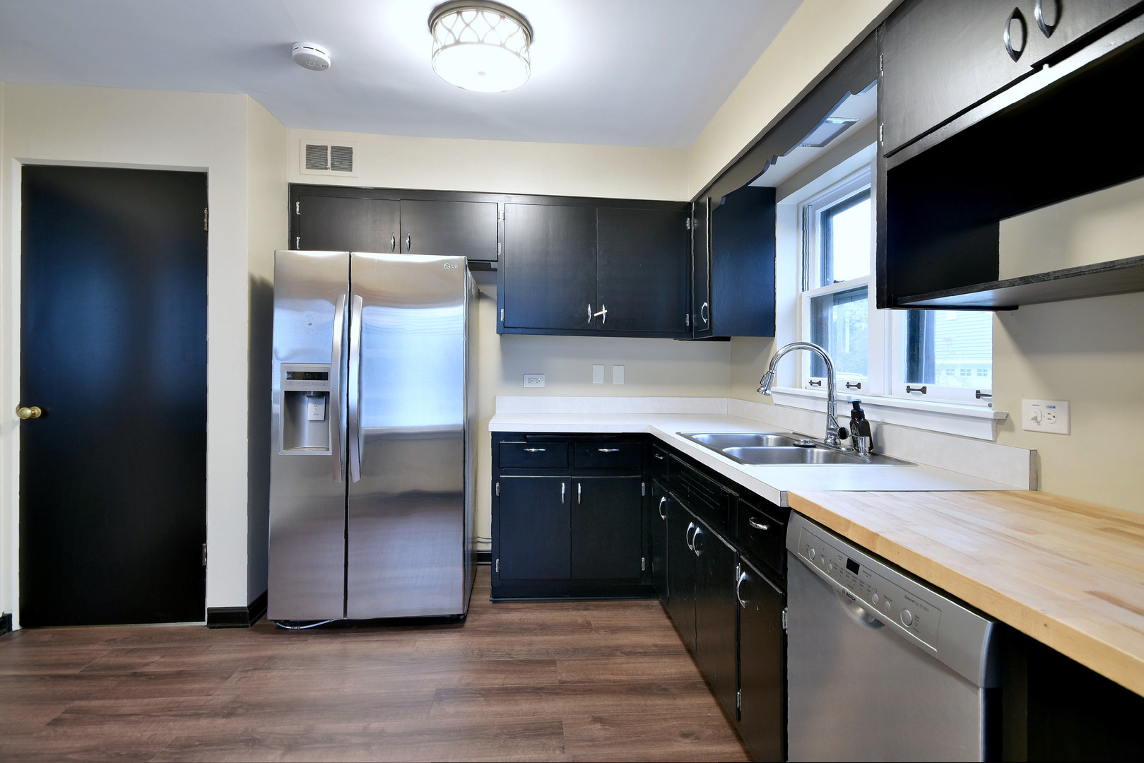 632 Bryan Street Elmhurst, IL 60126 - Photo 8 of 33 a kitchen with stainless steel appliances granite countertop a refrigerator a sink and a stove