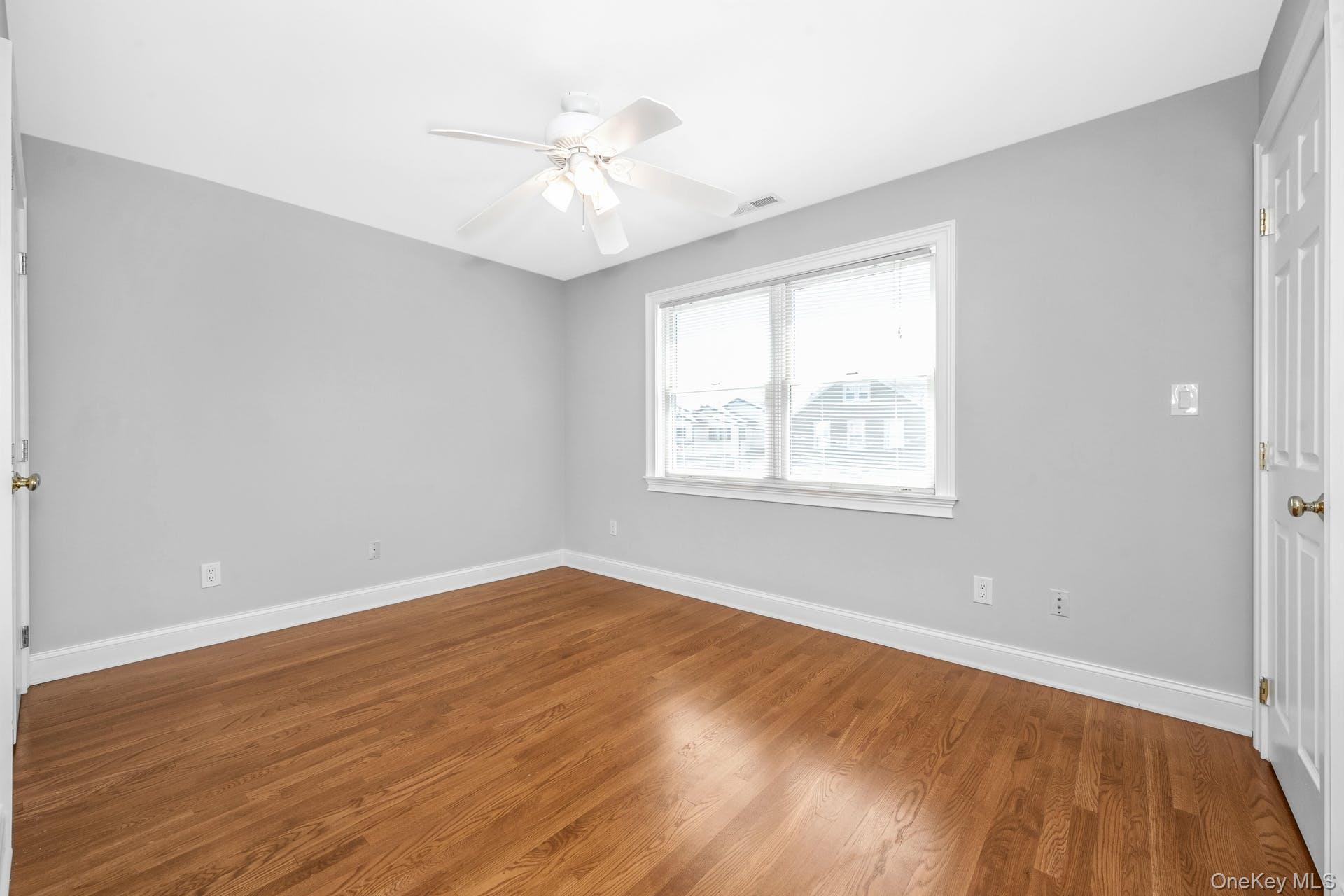69 Ellsworth Avenue Harrison, NY 10528 - Photo 12 of 28 Unfurnished room featuring wood finished floors and ceiling fan
