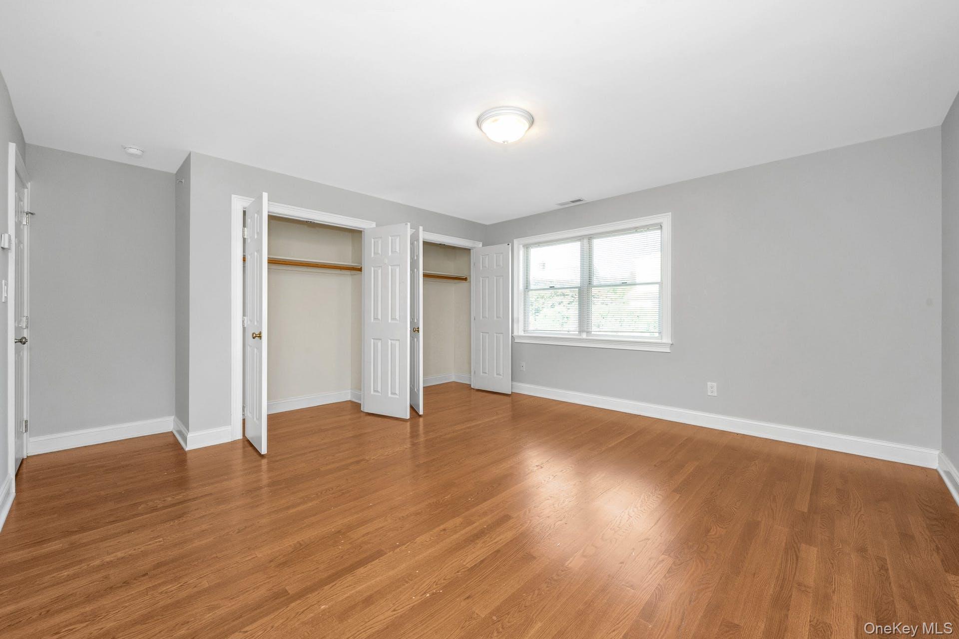 69 Ellsworth Avenue Harrison, NY 10528 - Photo 18 of 28 Unfurnished bedroom featuring light wood-style flooring
