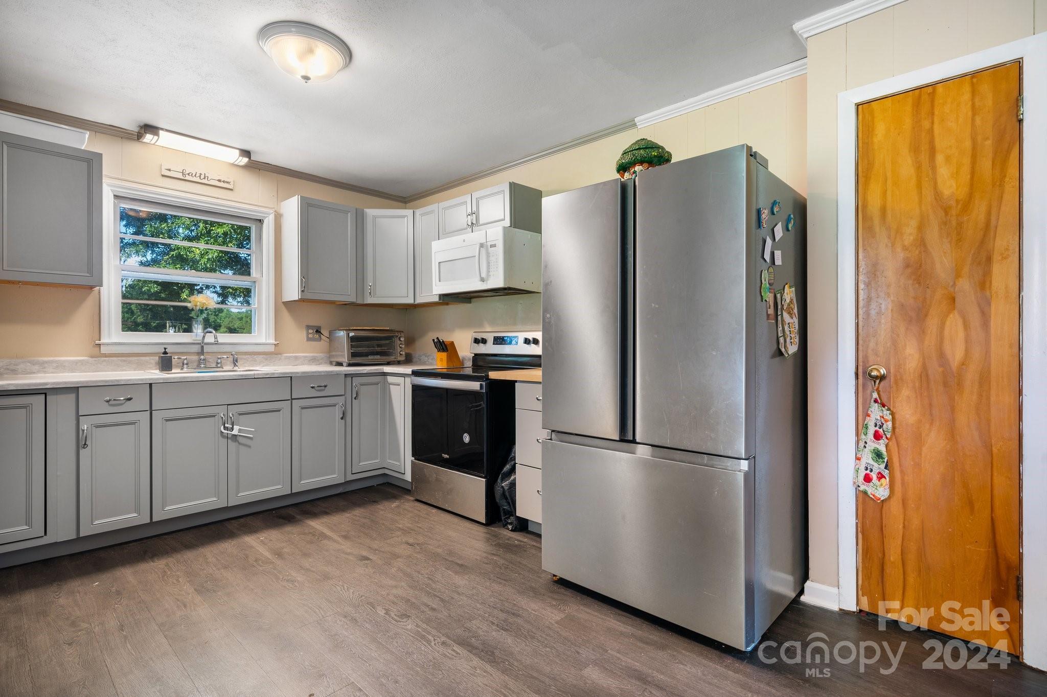 1675 Morningside Drive Newton, NC 28658 - Photo 11 of 36 a kitchen with a refrigerator a sink cabinets and wooden floor