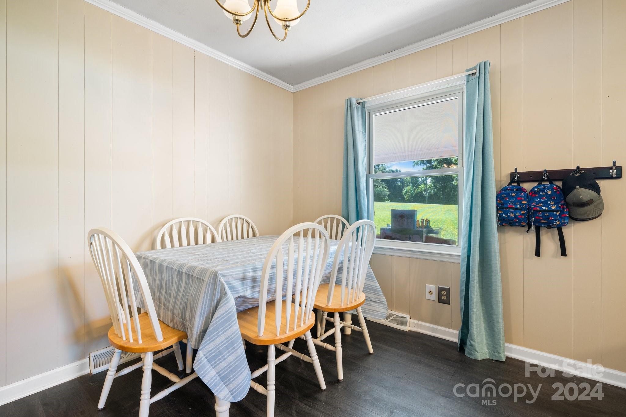 1675 Morningside Drive Newton, NC 28658 - Photo 14 of 36 a view of a dining room with furniture a chandelier and wooden floor