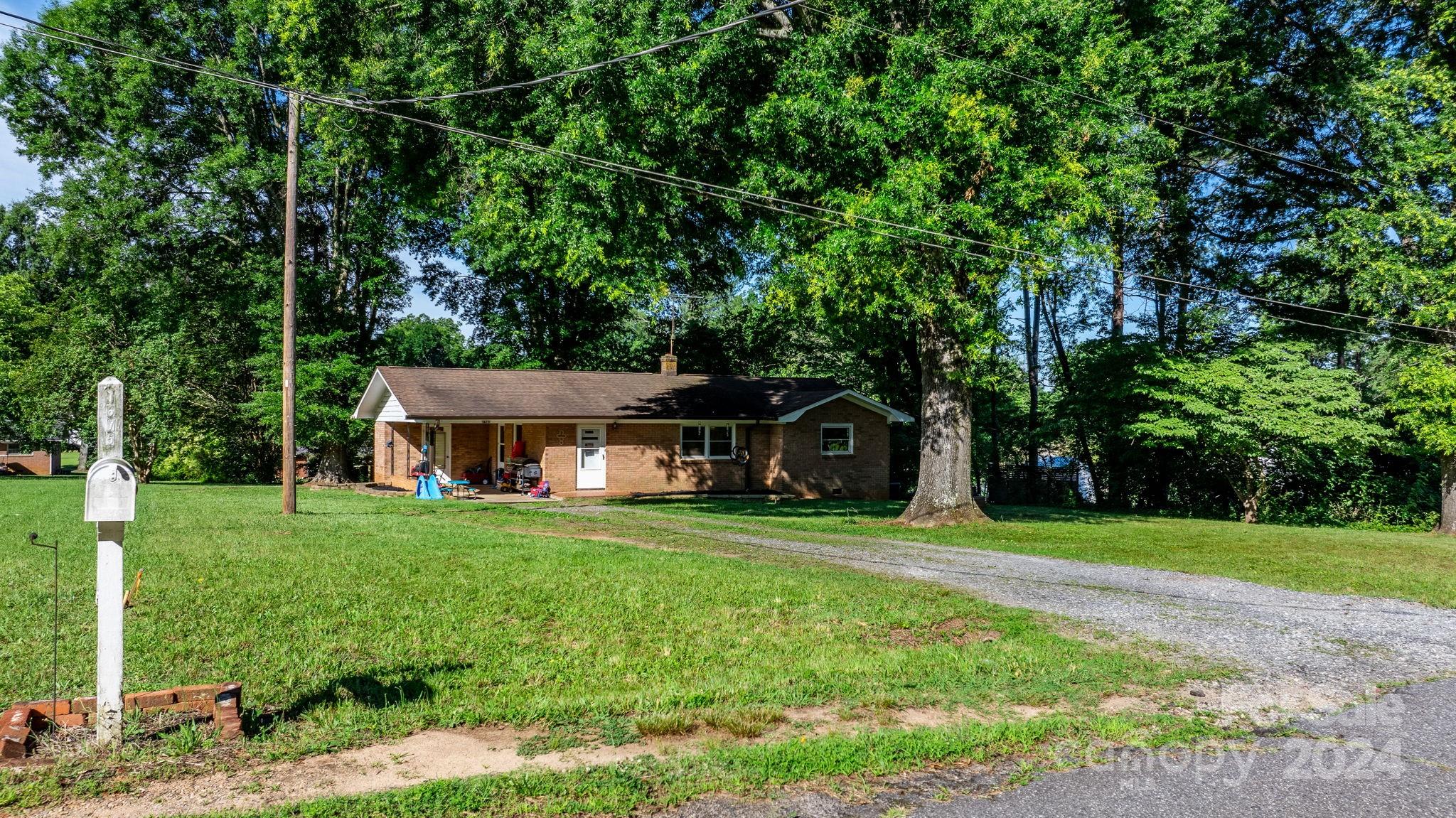 1675 Morningside Drive Newton, NC 28658 - Photo 2 of 36 a front view of a house with a garden