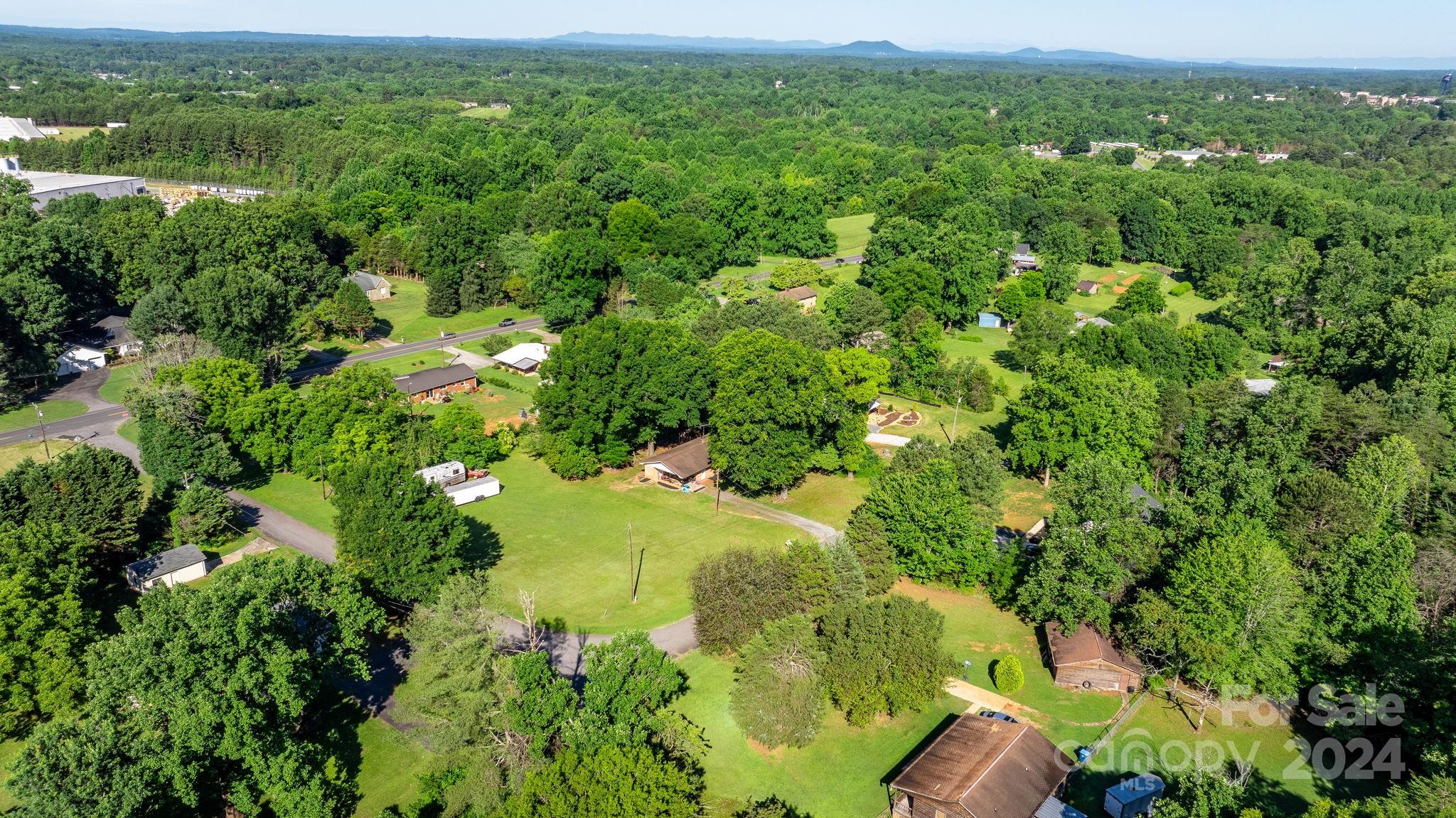 1675 Morningside Drive Newton, NC 28658 - Photo 33 of 36 a view of a lush green forest with trees in the background