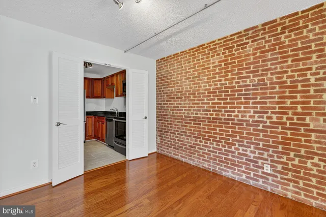 a view of empty room with wooden floor