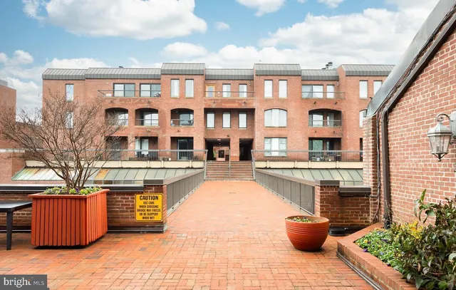 a front view of a house with outdoor seating and kitchen view