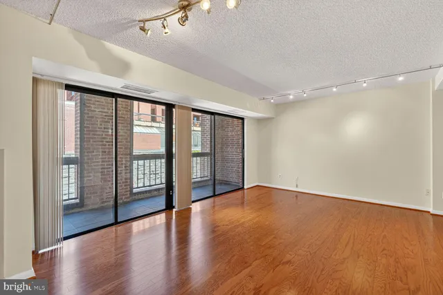 a view of an empty room with glass door