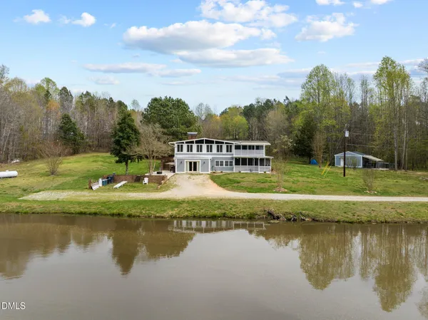 a view of a lake with a house in the background