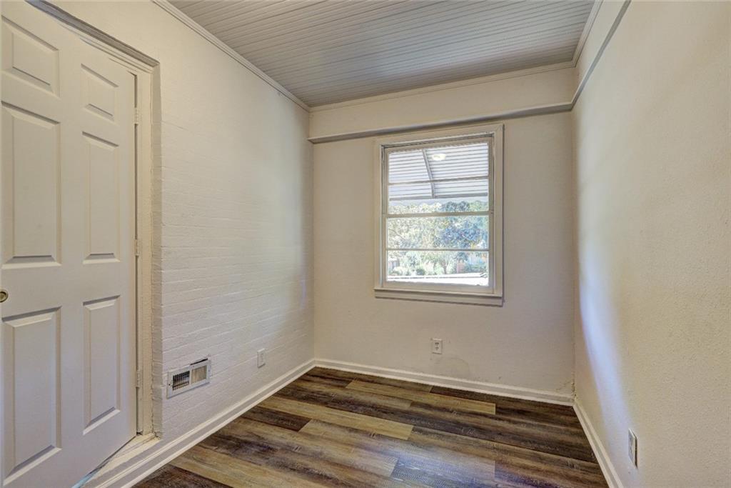2128 Knightsbridge Road Macon, GA 31211 - Photo 11 of 12 a view of an empty room with wooden floor and a window