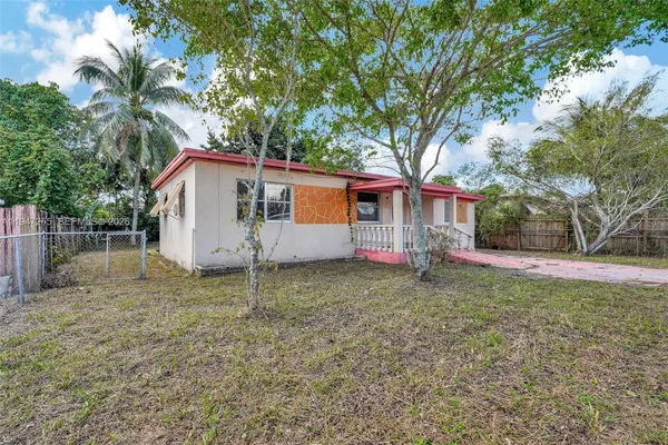 a house that has a tree in front of it