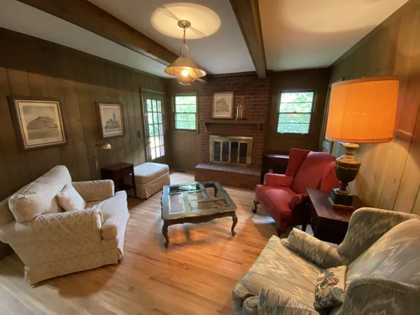 a view of a hallway with wooden floor and closet