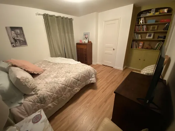 a large bed sitting in a bedroom next to a window