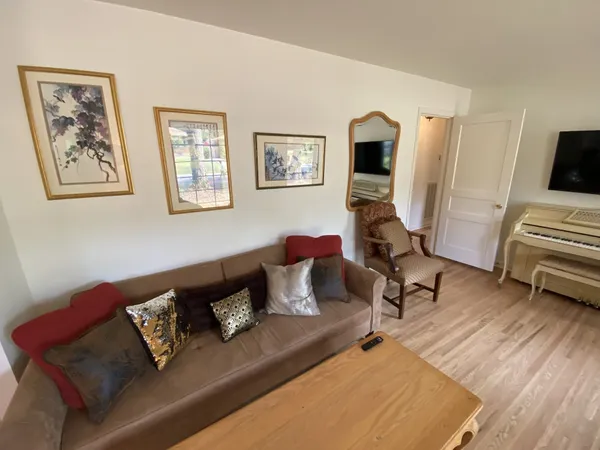 a living room with furniture and wooden floor