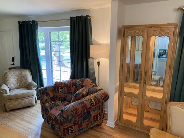 a view of a dining room with furniture and wooden floor