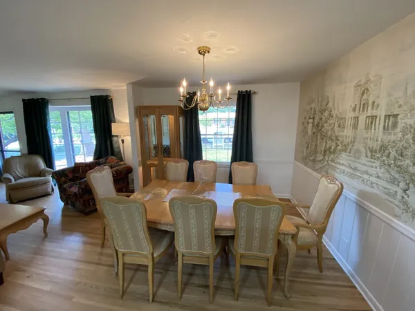 a view of a dining room with furniture and wooden floor