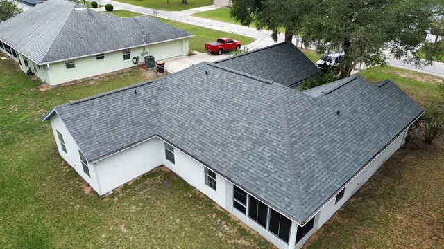an aerial view of a house with a yard