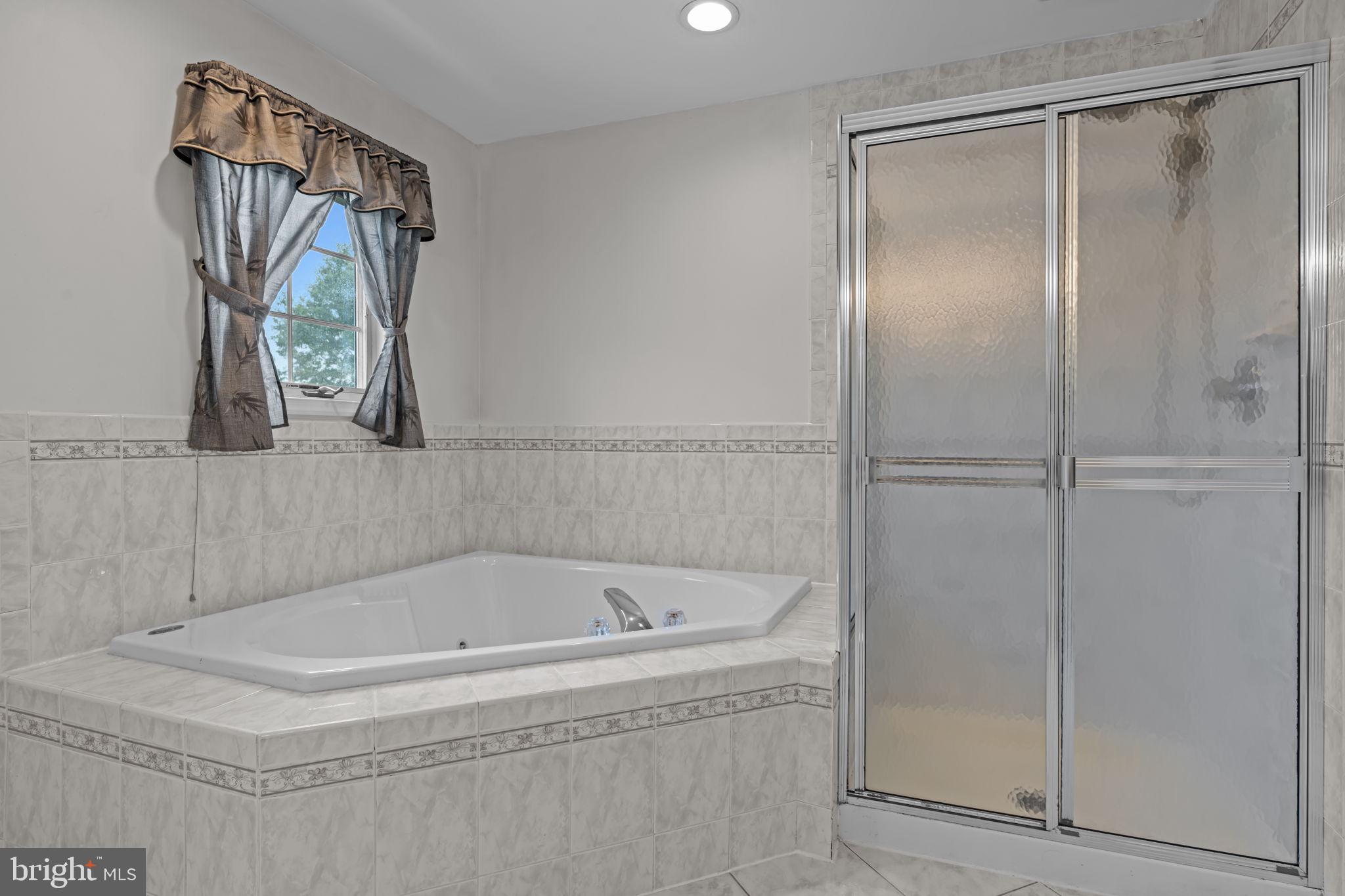 18 Lea Drive Hamilton, NJ 08690 - Photo 38 of 44 a bathroom with a tub and a shower