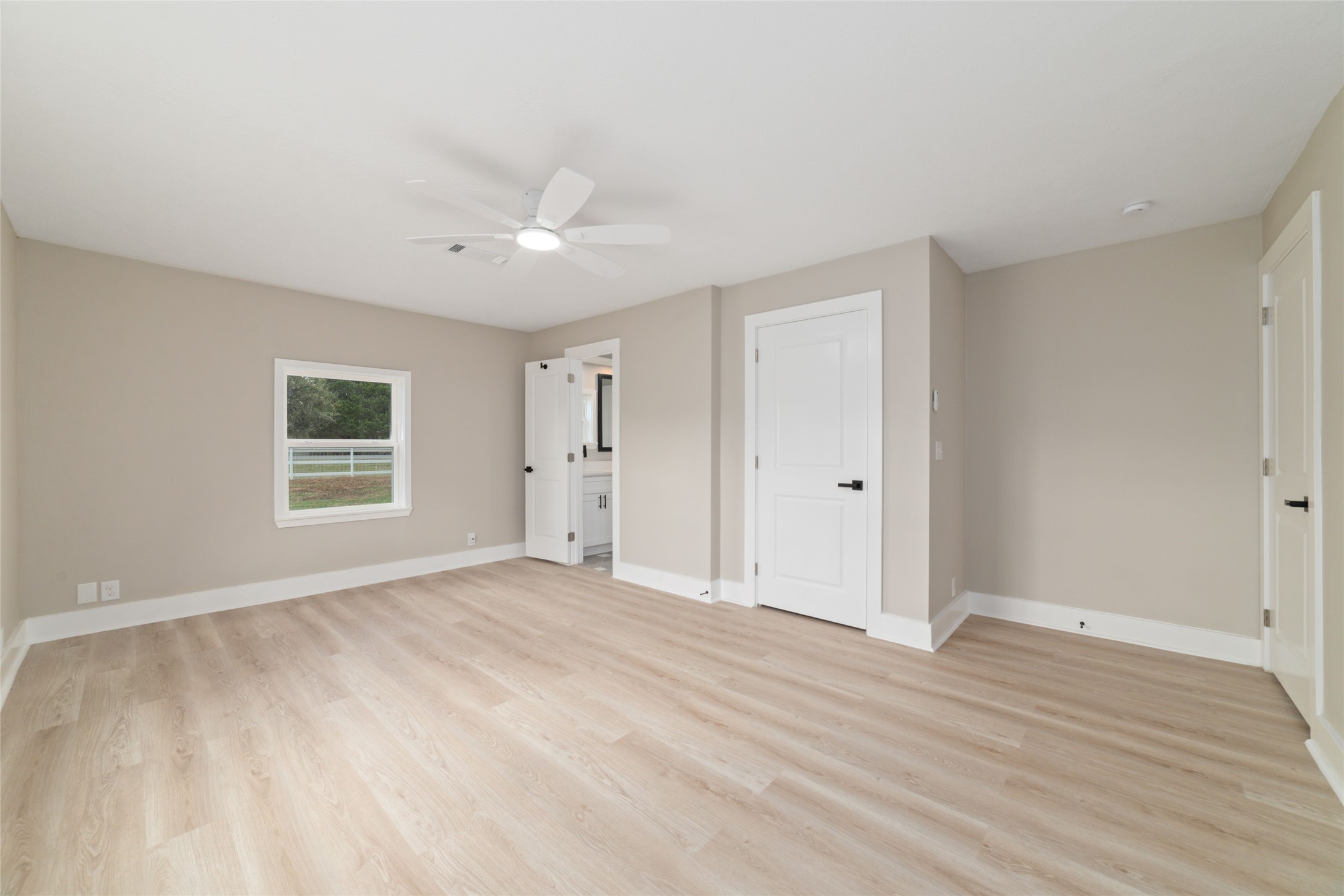 13431 Vrlla Road Guy, TX 77444 - Photo 17 of 32 a view of an empty room with wooden floor and a window