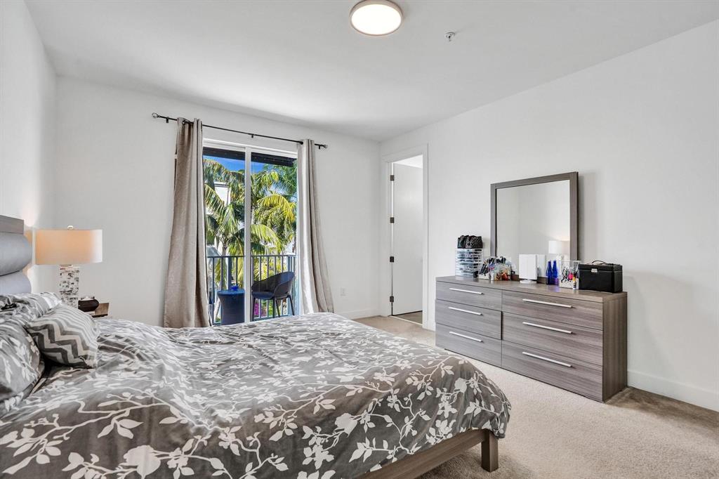 480 Northeast 35th Court, Unit 2 Oakland Park, FL 33334 - Photo 12 of 35 a bedroom with a bed and a dresser