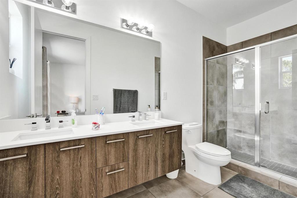 480 Northeast 35th Court, Unit 2 Oakland Park, FL 33334 - Photo 15 of 35 a bathroom with a sink toilet and shower