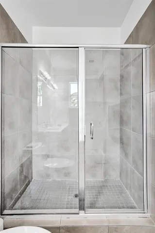 a bathroom with a glass shower door