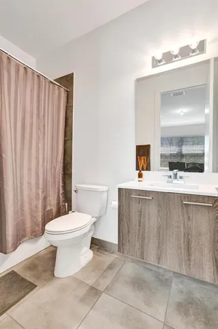 a bathroom with a sink a toilet a mirror and vanity